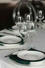 Served for wedding restaurant table with dishes, glasses,  cutlery