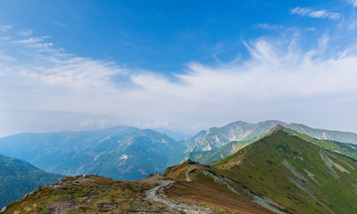 Fototapeta premium Tourists walking along the ridges of the mountains in the Tatras