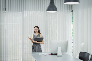 Portrait of beautiful young businesswoman working and happy with her coffee in the office., Happy working.