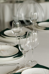 Served for wedding restaurant table with dishes, glasses,  cutlery