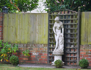 Old statue of a woman in a garden