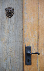Old metal door handle of a wooden door