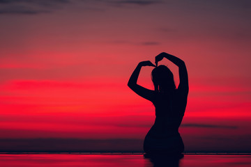 Beautiful women heart-shaped gestures, silhouette style