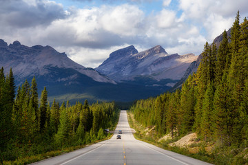 Fototapeta premium Scenic road in the Canadian Rockies during a vibrant sunny summer day. Taken in Icefields Parkway, Banff National Park, Alberta, Canada.