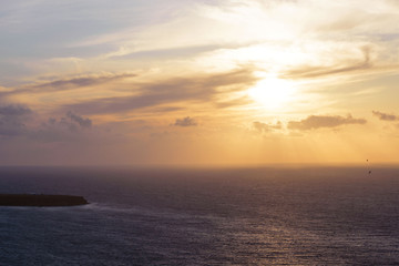 Naklejka na ściany i meble Beautiful sunset at the sea on Santorini island, Greece. Romantic trip.