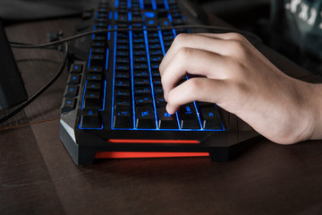 Gamer keyboard with colorful blue lights, modern gamer computer. Blue backlight, backlit on laptop or keyborad computer of gaming.