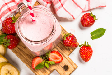 Strawberry milkshake or smoothie in mason jar.
