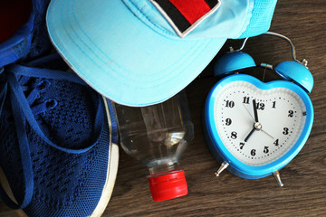 Close up of clock and sneakers - Fitness Concept