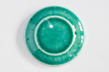 round clay sample covered with turquoise glossy glaze.