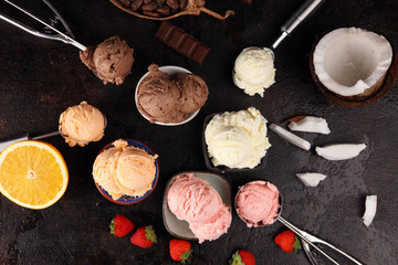 Set of ice cream scoops of different colors and flavours with berries, chocolate and fruits on background