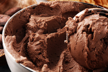 Chocolate coffee ice cream in a bowl on rustic white table