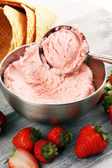 Strawberry ice cream scoop on a rustic white background