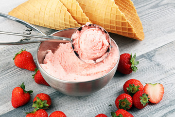 Strawberry ice cream scoop on a rustic white background