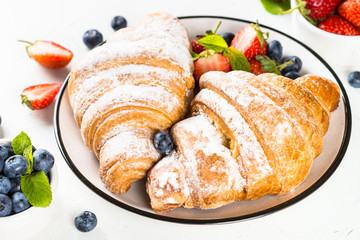 Croissant with chocolate and fresh berries.