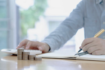 Saving money concept Man hand putting Row and coin stack growing business