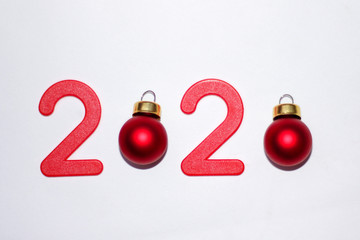 new year 2020. red numbers and Christmas toys on the Christmas tree in the form of balls, minimalism, space for text. top view