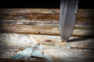 knife blade on wooden background