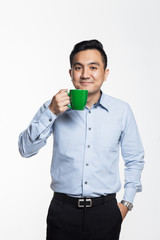 Good looking asian man holding a coffee mug