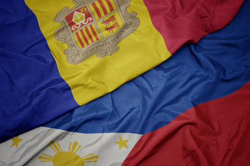 waving colorful flag of philippines and national flag of andorra.