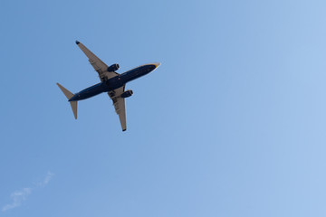 Airplane flying in the blue sky with copy space
