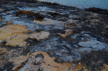Salt on the rocks on the shores of Ibiza. Surface of mars. Cosmic beauty