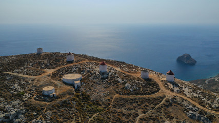 Aerial drone photo of picturesque windmills in main town or chora of Amorgos island built on top of...
