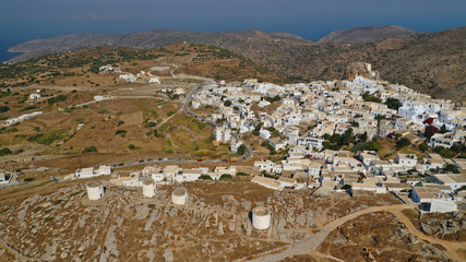 Obraz premium Aerial drone panoramic photo of picturesque main village or chora and castle of Amorgos island built on top of cliff overlooking the Aegean blue sea, Cyclades, Greece