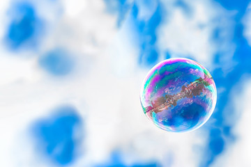 air soap bubble against the sky, the reflection of the city in the sphere, the concept of clean air in the big city, environmental protection