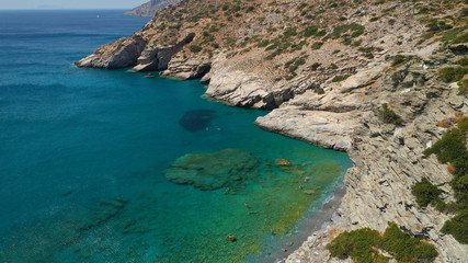 Aerial drone photo of paradise small beach of Mouros with caves and crystal clear sea, Amorgos...