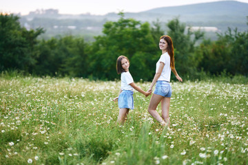 Fototapeta premium mother and daughter in the field
