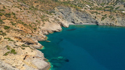 Aerial drone photo of paradise small beach of Mouros with caves and crystal clear sea, Amorgos...