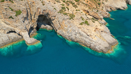 Aerial drone photo of paradise small beach of Mouros with caves and crystal clear sea, Amorgos...