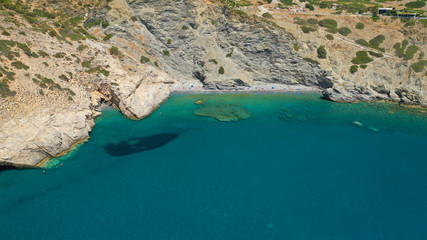 Aerial drone photo of paradise small beach of Mouros with caves and crystal clear sea, Amorgos...