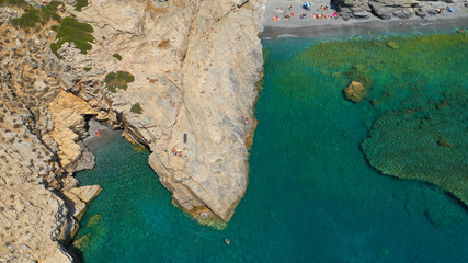 Aerial drone photo of paradise small beach of Mouros with caves and crystal clear sea, Amorgos...