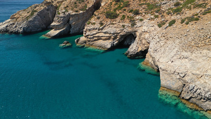 Aerial drone photo of paradise small beach of Mouros with caves and crystal clear sea, Amorgos island, Cyclades, Greece