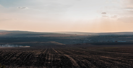Tractor plows the field in autumn season.