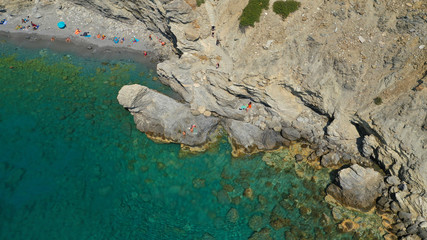 Aerial drone photo of paradise small beach of Mouros with caves and crystal clear sea, Amorgos island, Cyclades, Greece