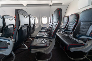 Airplane seats and windows. Economy class comfortable seats without passengers. New low-cost...