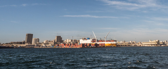 Naklejka premium Dakar, Senegal - February 2, 2019: Panoramic view of the port of Dakar in Senegal with big ships, small boats, cranes and cargos near the quay. Africa.
