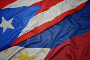 waving colorful flag of philippines and national flag of puerto rico.