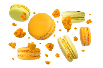 Yellow  french macaroons falling or flying in motion on white background.