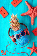 Pineapple character sunglasses and earphones listens to the music.  Rustic textured wooden...