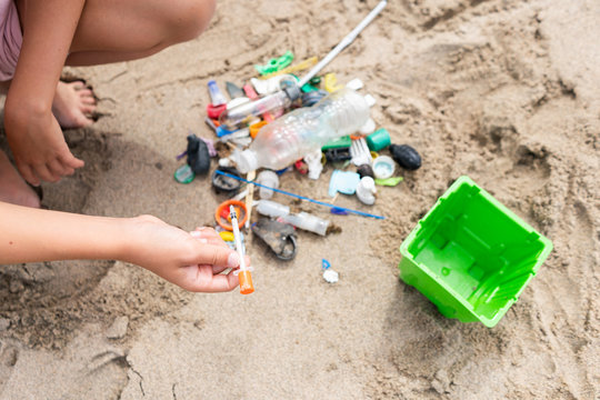 Close up view of non biodegradable waste collected by child