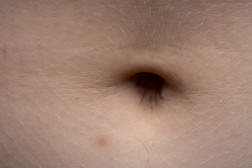 Macro photo of the young pink human's navel