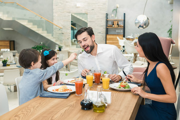 Family Sitting Together in the Restaurant Lunch Concept