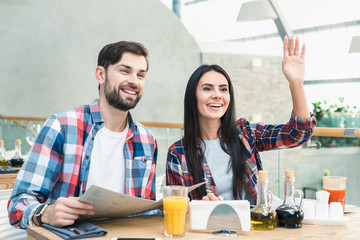 Young Man and Woman Sitting in the Restaurant Concept