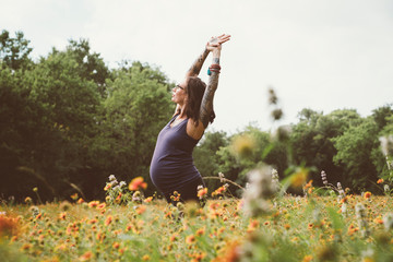 Pregnant woman doing exercise in garden