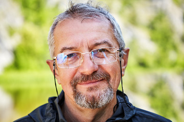 Smiling intellectual with glasses and a beard.