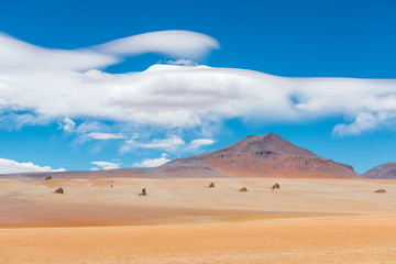 The magnificent Dali Desert near the Uyuni Salt Flat (Salar de Uyuni) with rock formations and clouds that could have been drawn by the master himself, Bolivia, South America.