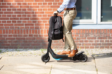Young Man Riding An Electric Scooter
